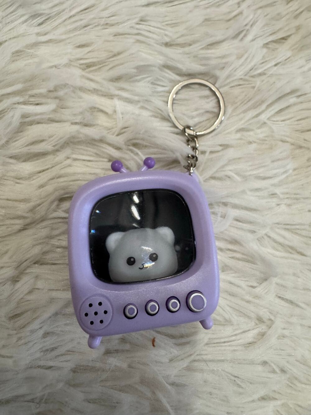 Purple cat on a Tv clicker light up keychain